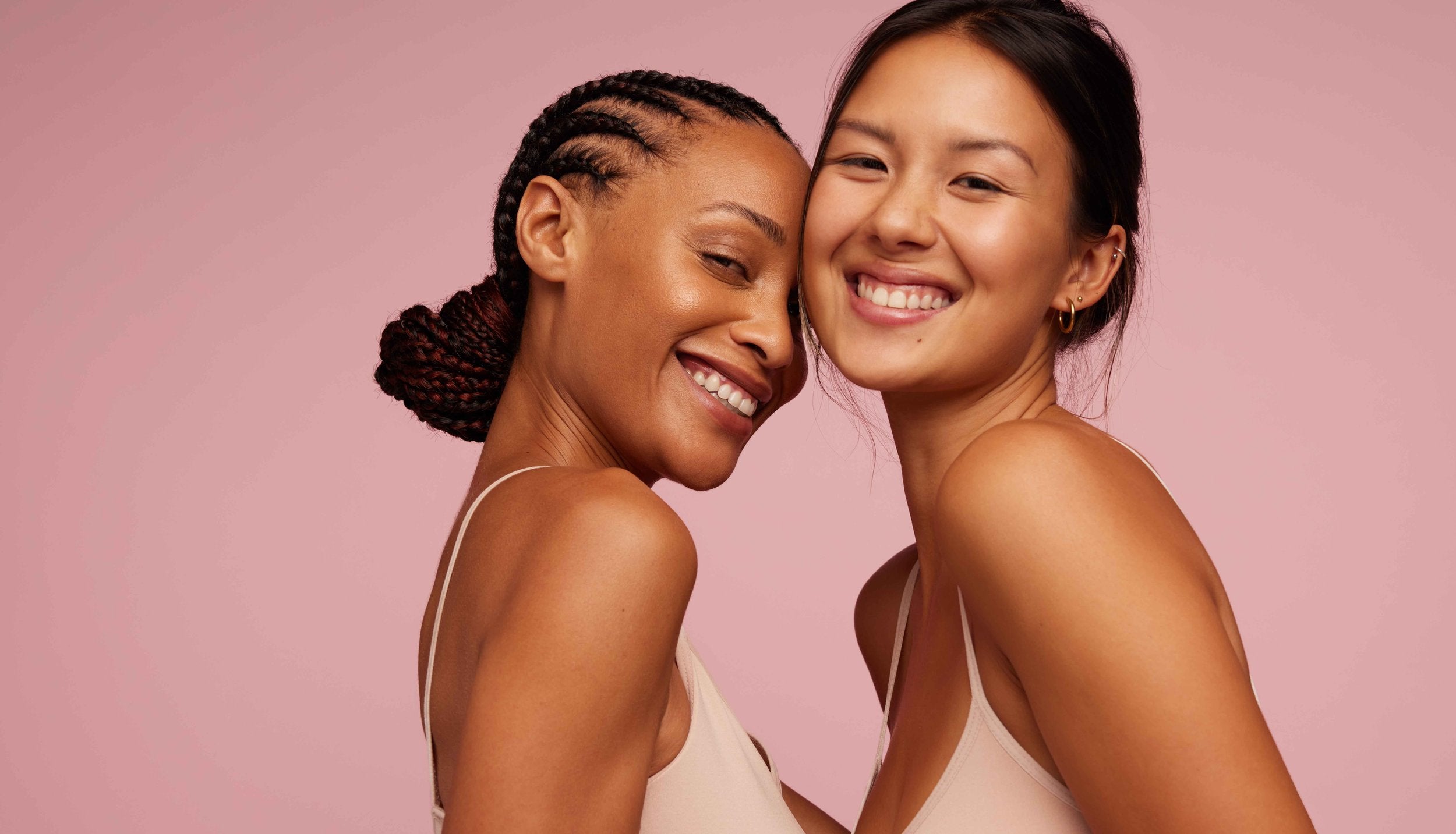 women smiling and embracing skin with | skin luxe natural